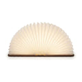 Lampe de bureau enfant Conte, livre en bois ouvert en éventail lumineux, finition noyer, sur fond blanc — Candeora