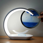 Main faisant pivoter le disque de sable de la lampe de bureau sans fil Sirocco Candeora