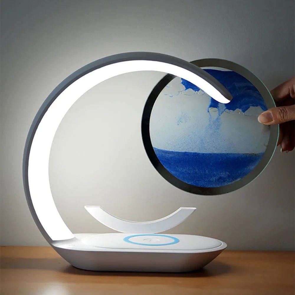 Main faisant pivoter le disque de sable de la lampe de bureau sans fil Sirocco Candeora